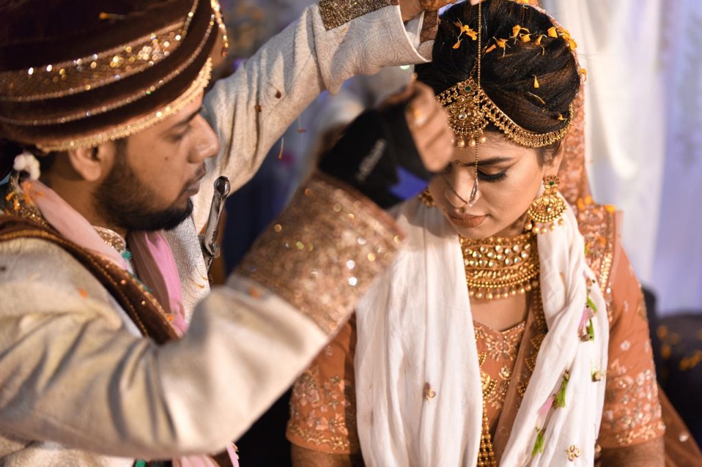 Close-up of traditional Indian wedding ceremony with bride and groom exchanging rituals.